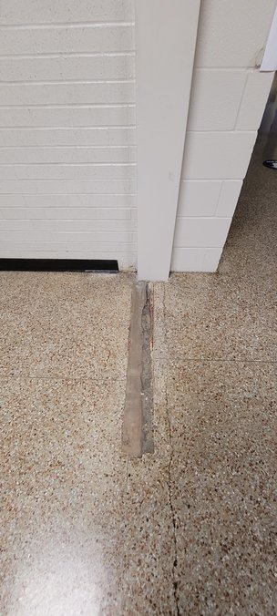 Multiple partial walls have been cut out of the Royal Junior High campus including at this location at the intersection of two hallways as well as partial walls in the restrooms. The cutouts leave an uneven floor that could make it difficult for disabled students to move about and generally create a tripping hazard.